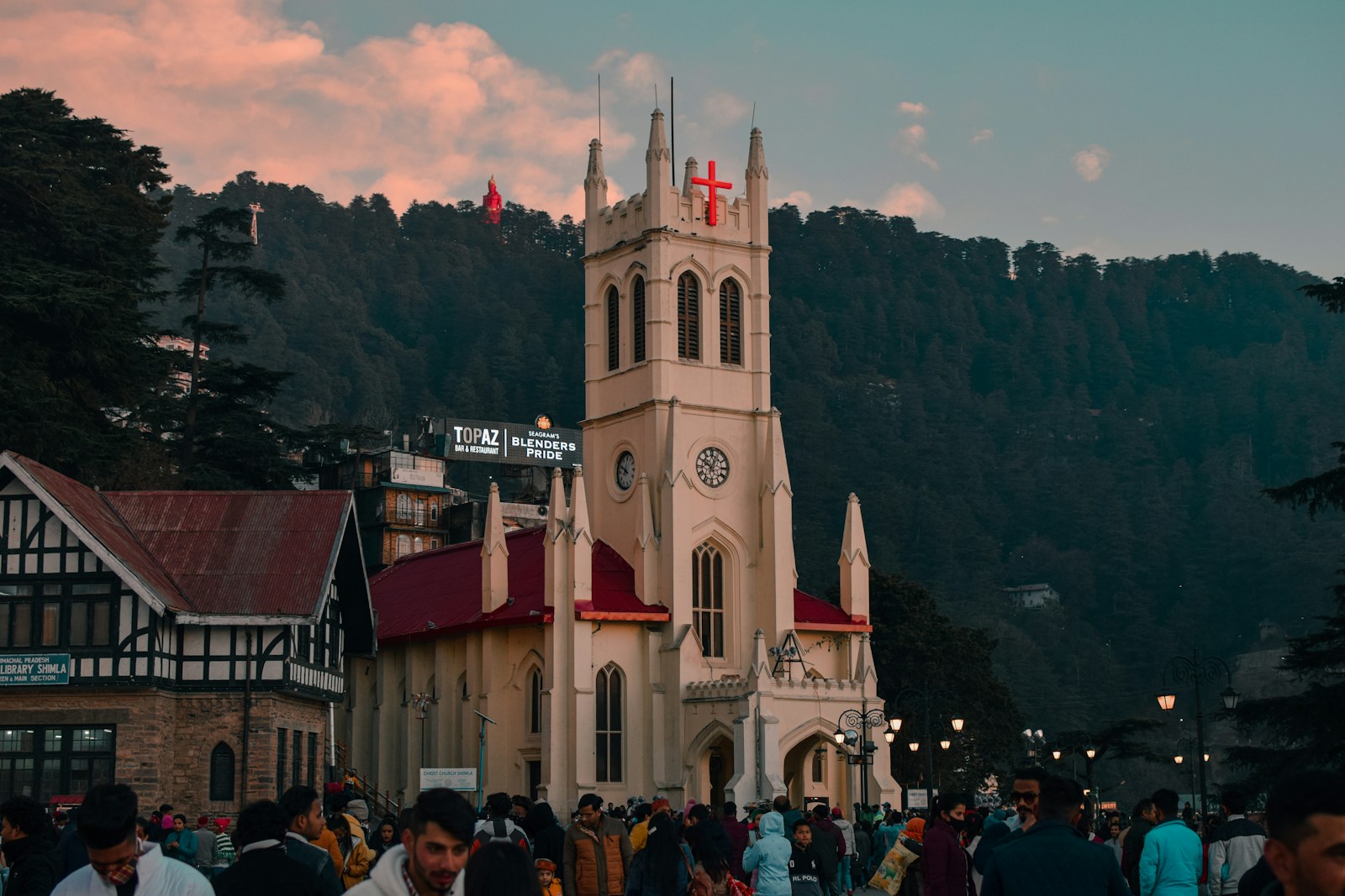 a crowd of people walking around a church