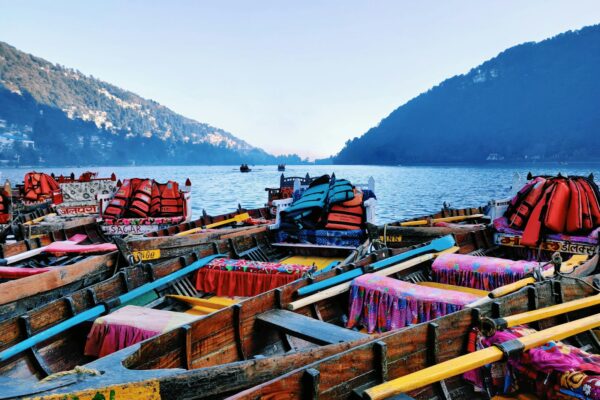 red and blue boat on sea shore during daytime